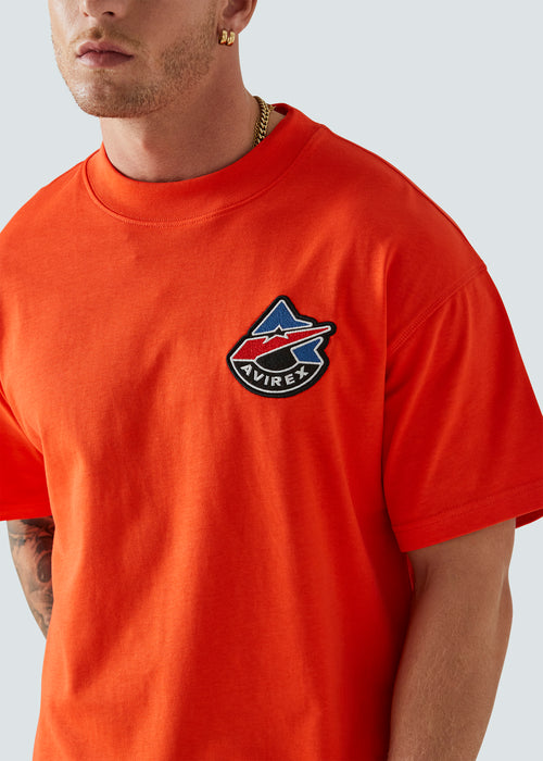 Orange Avirex t-shirt with embroidered logo close up
